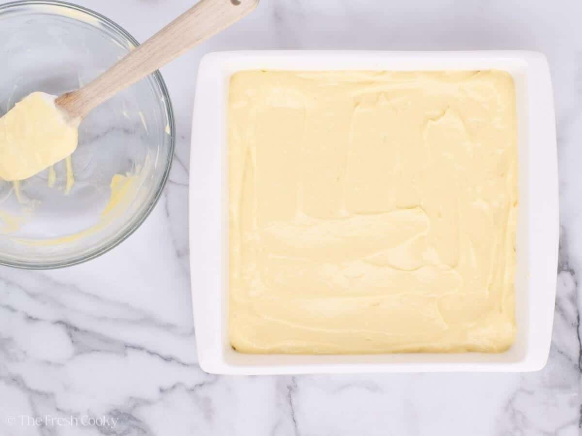 Layer of custard on top of the puff pastry in a white baking dish.
