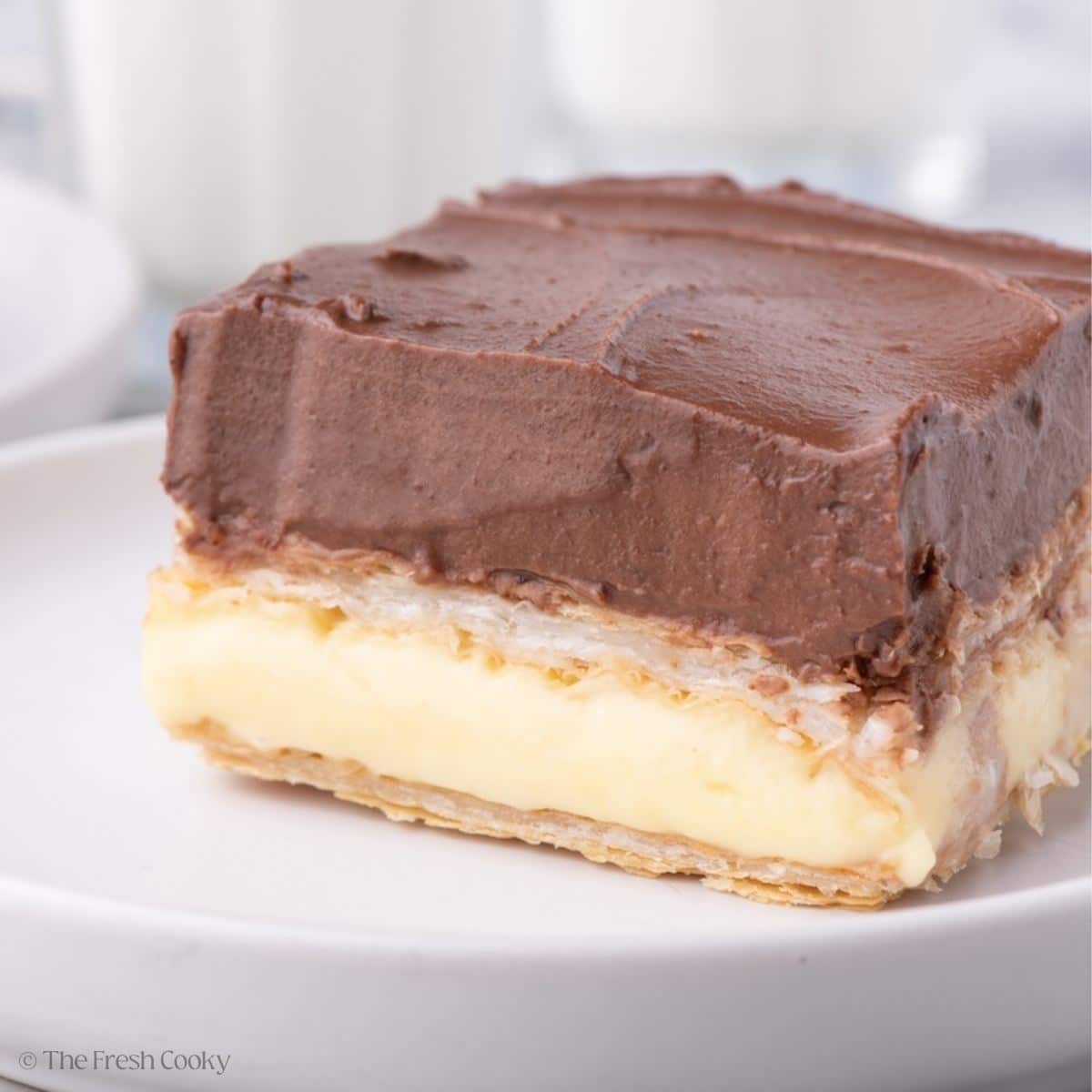 Slice of chocolate eclair cake on a plate.