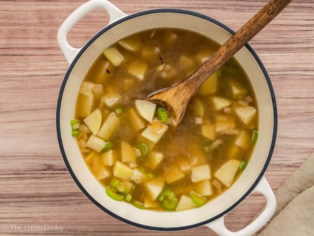 Broth and diced potatoes added to the stock pot.