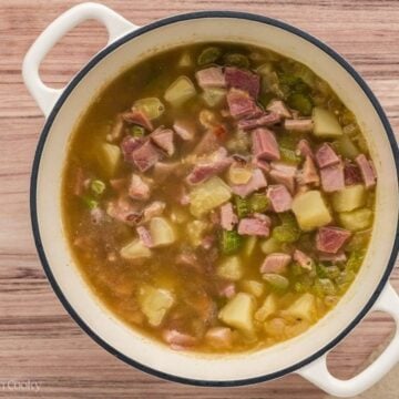 Diced ham added to the soup in a large stock pot.