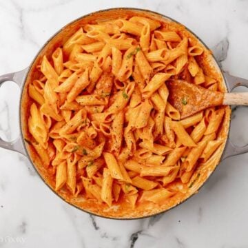 Pasta and vodka sauce combined in pan.