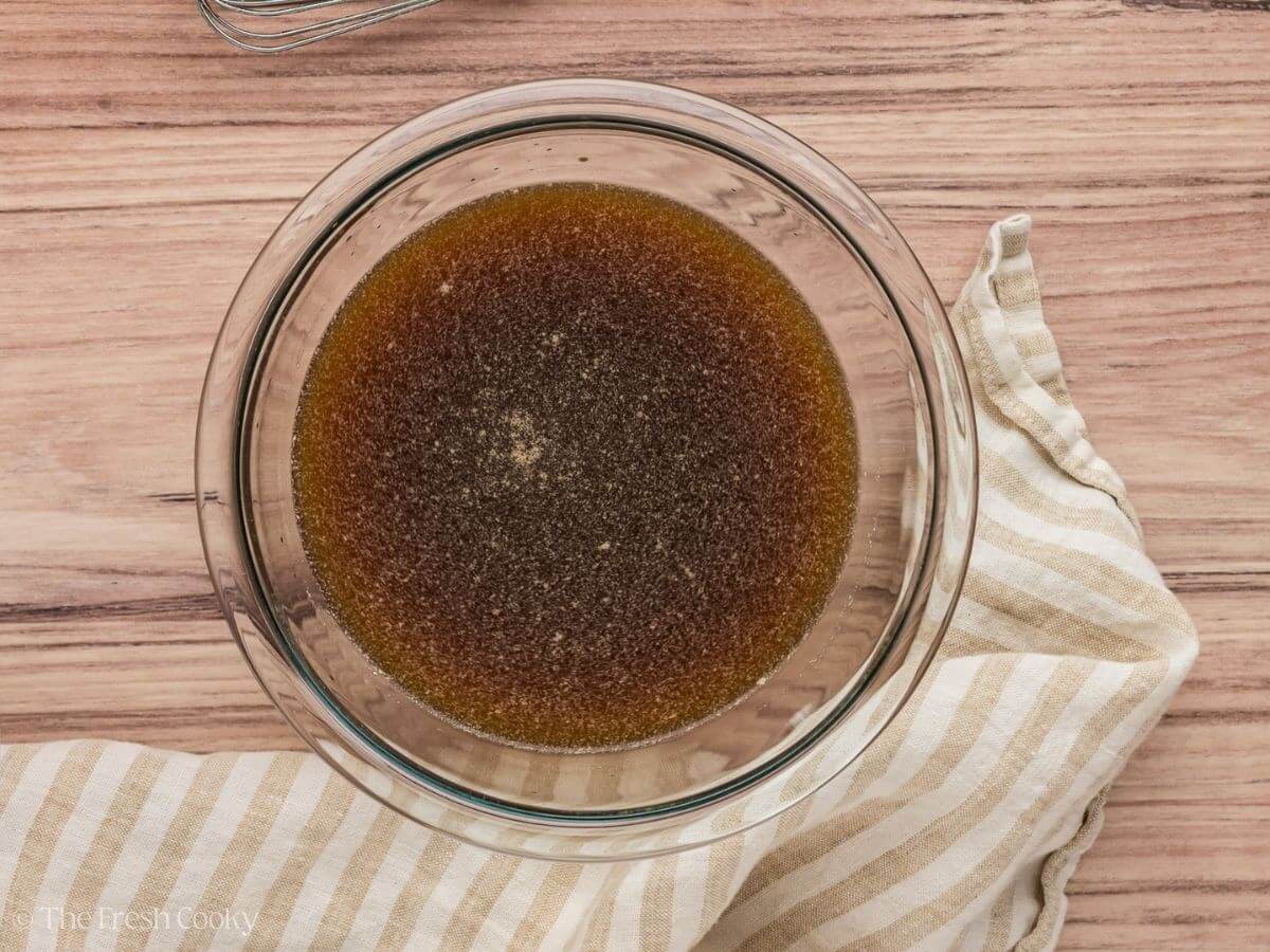 Beef broth, bouillon and Worcestershire sauce in a small bowl.