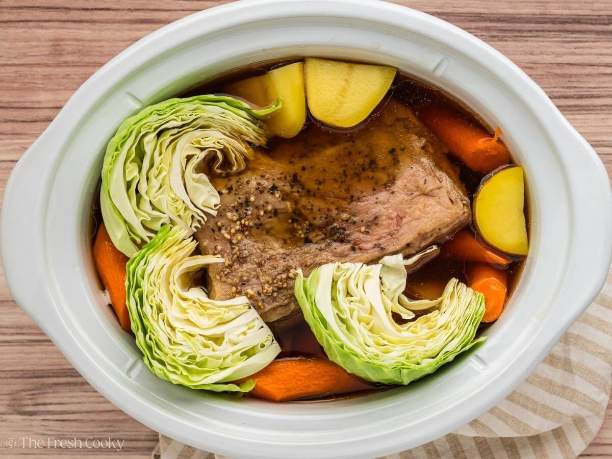 Carrots, potatoes and cabbage added to the crock pot with the brisket.