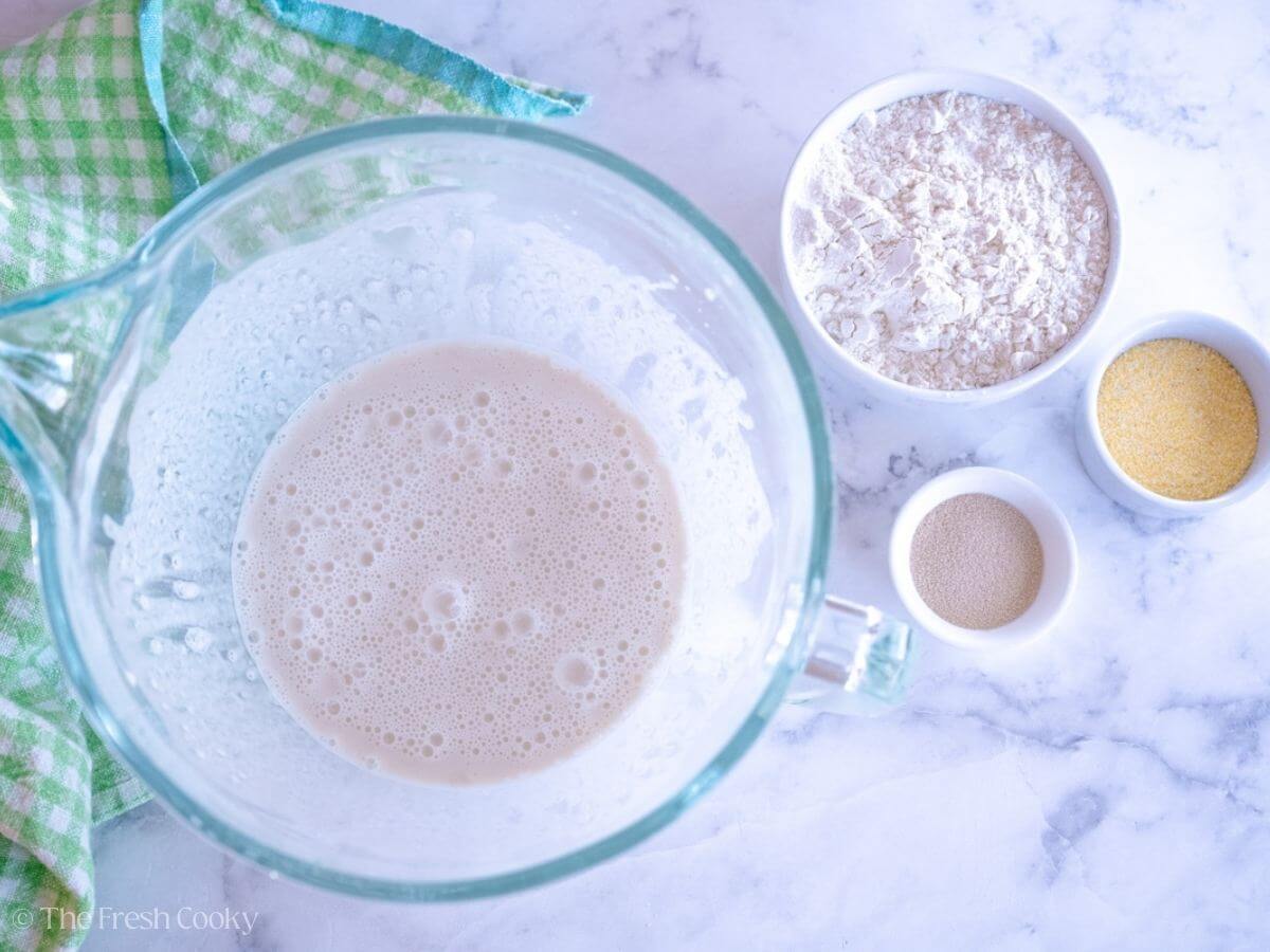 Yeast blooming in the warm water and milk in a stand mixer bowl.