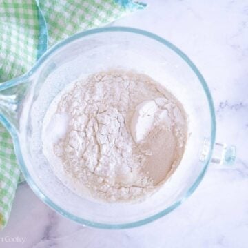 Flour added to the liquid in a large mixing bowl.