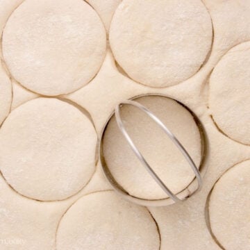 Cutting out circle shapes from the English muffin dough.