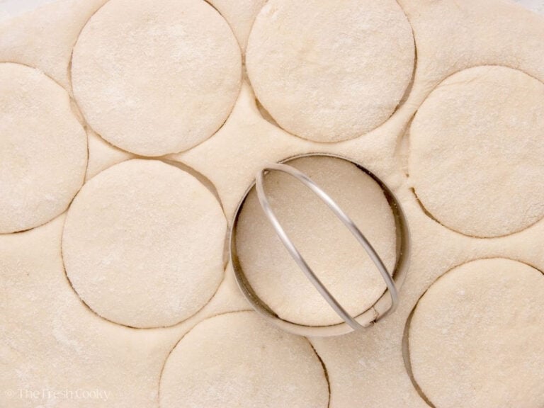 Cutting out circle shapes from the English muffin dough.