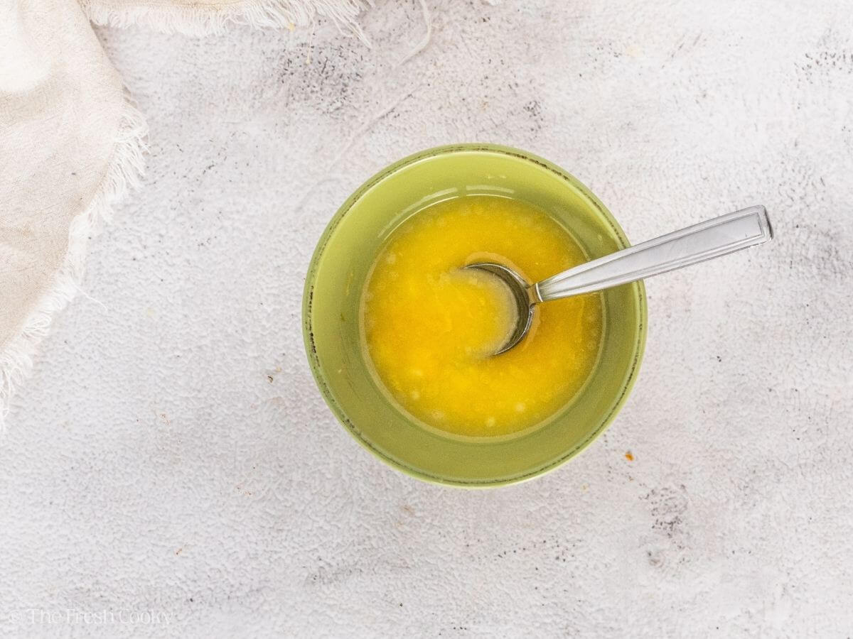 Lemon butter sauce in a small bowl after being mixed together.