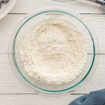 Dry ingredients sifted into a glass mixing bowl.