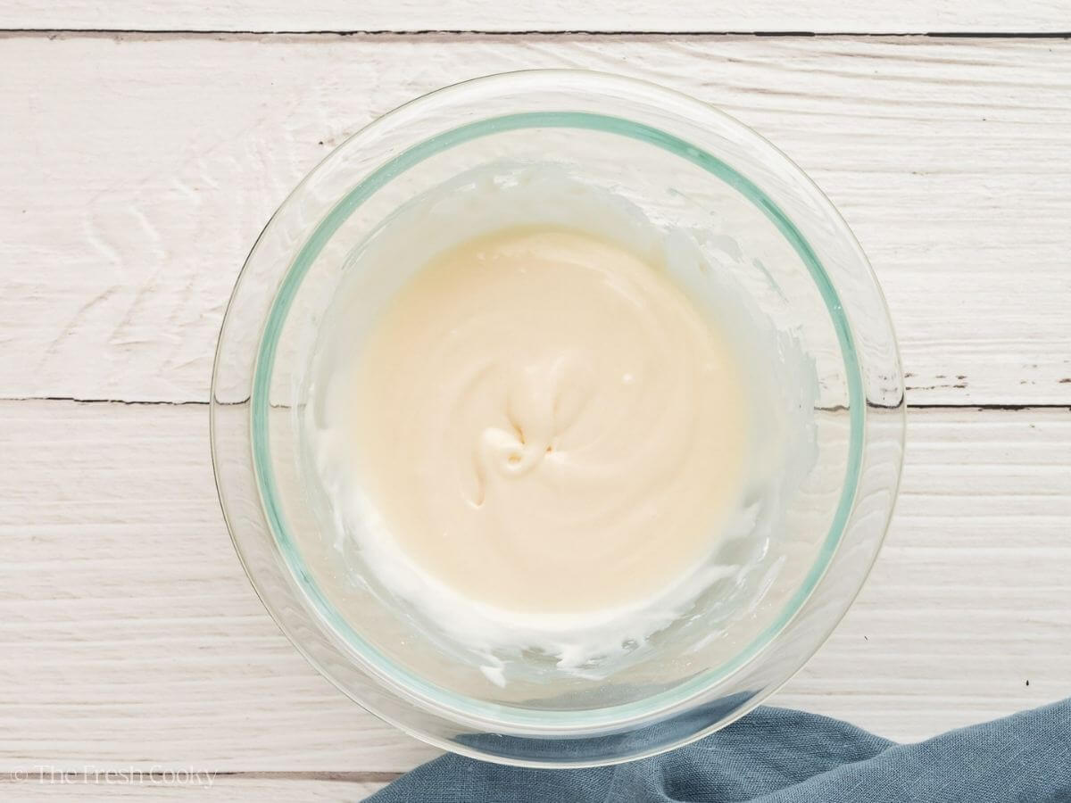 Lemon glaze mixed together in a small glass bowl.