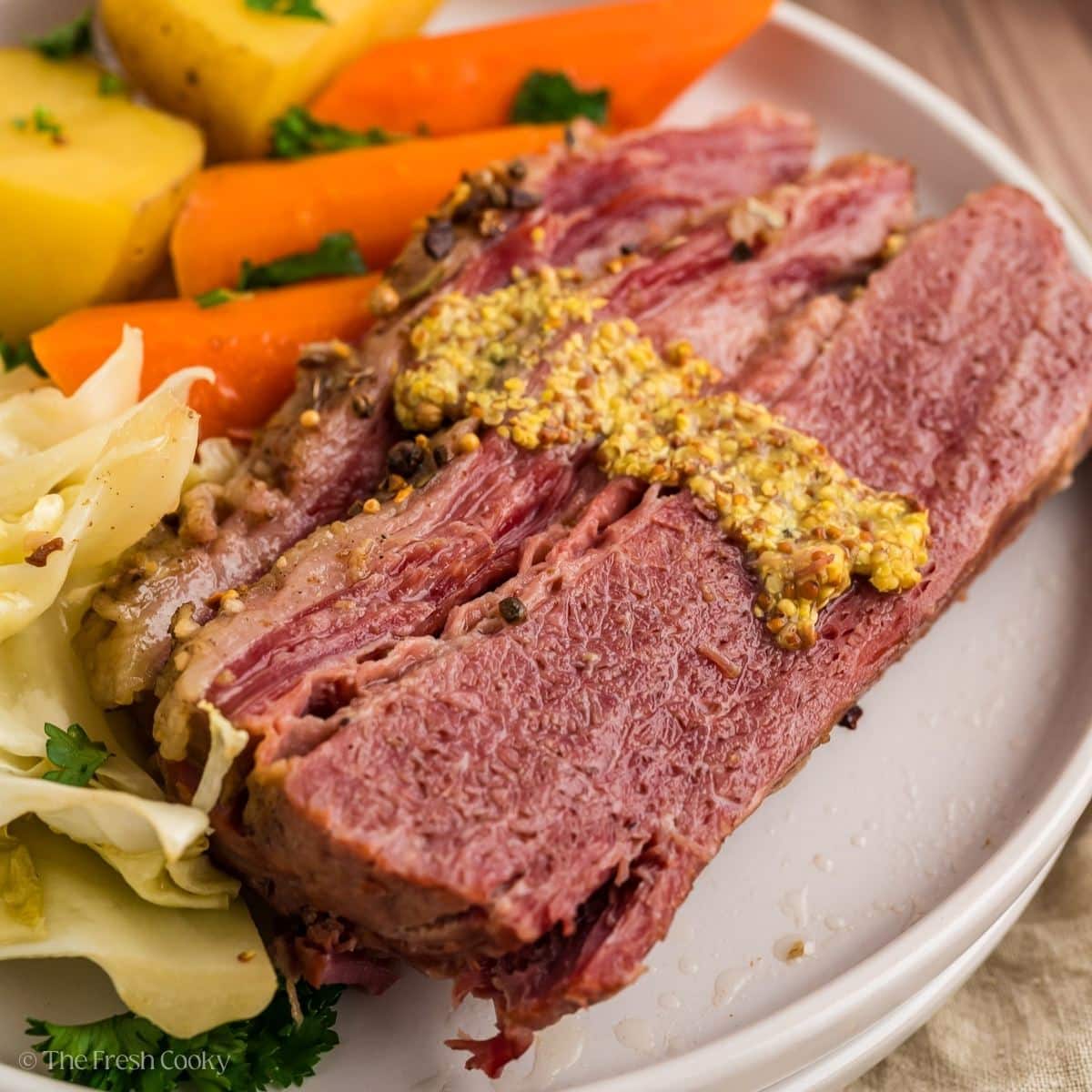 Slices of corned beef with cabbage, carrots and potatoes.
