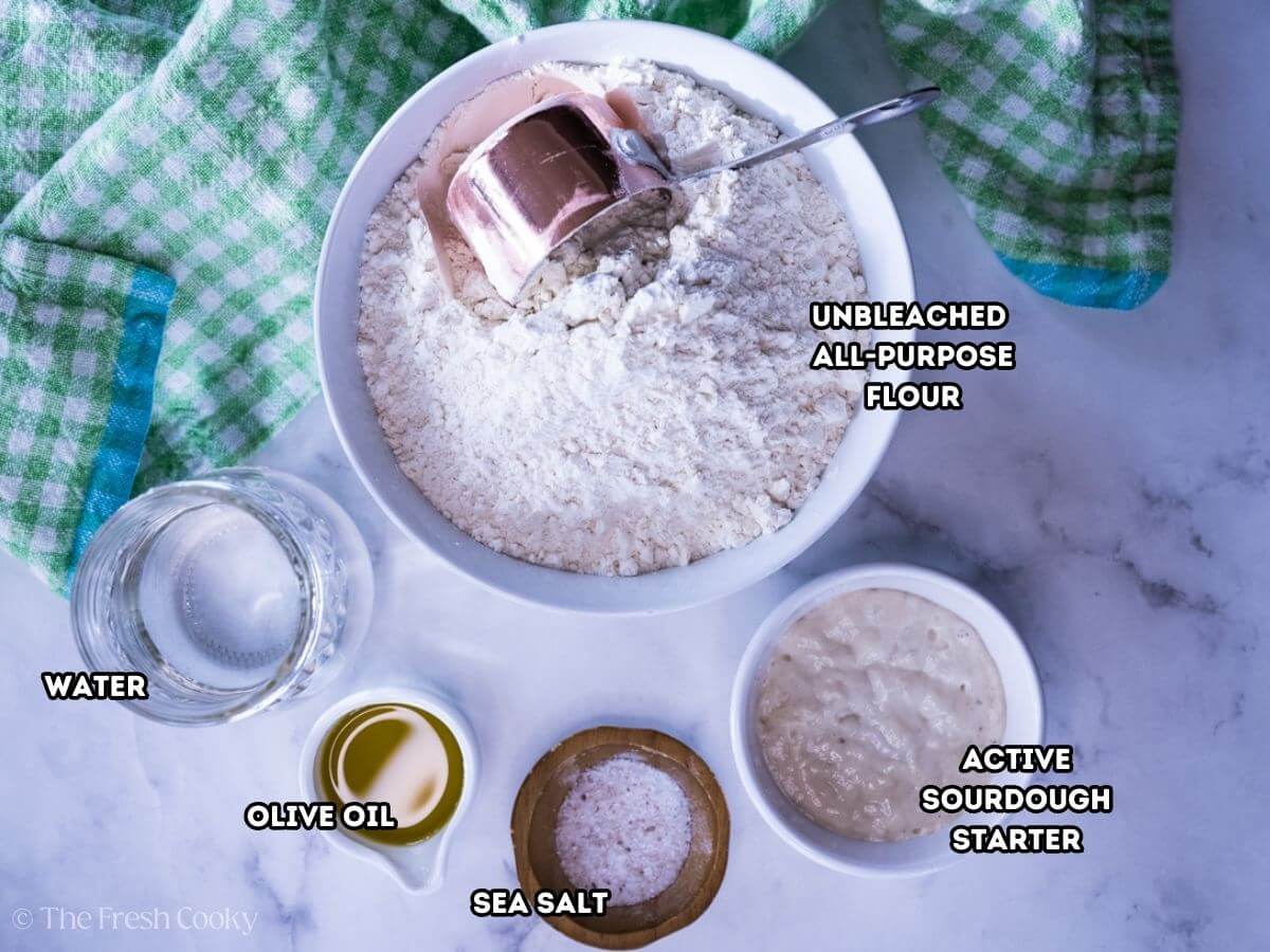 Ingredients needed to make sourdough pizza dough from scratch.