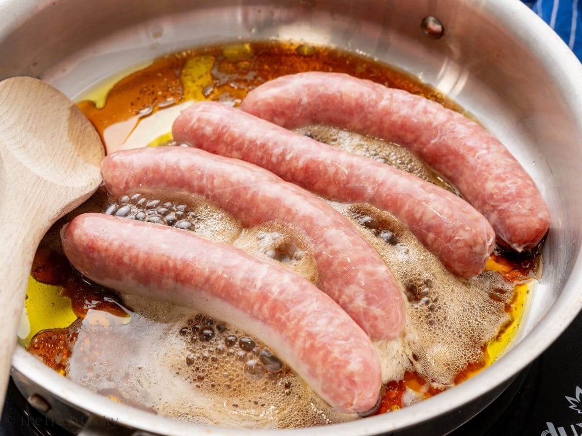 Add sausages to hot pan with oil and beer. 