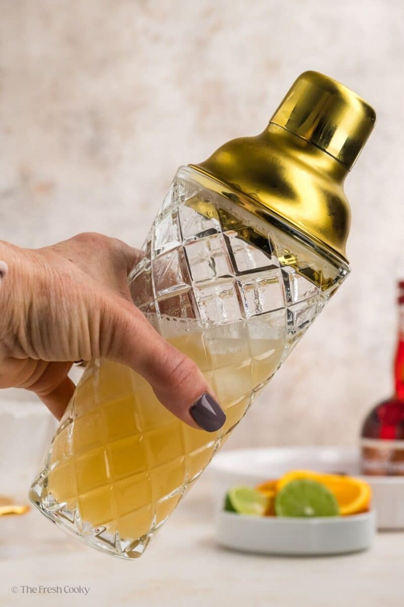 Shaking Cadillac margarita in cocktail shaker. 