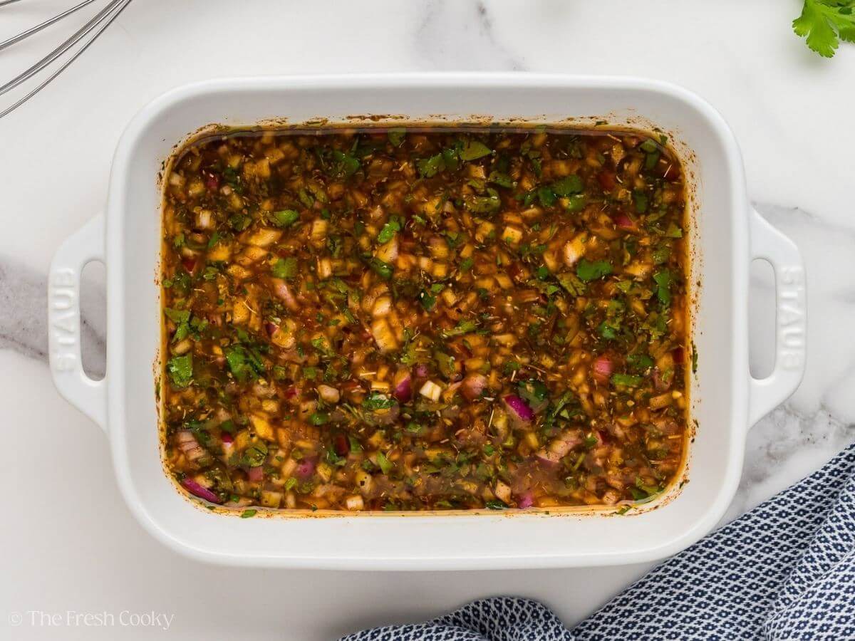 Marinade for flank steak in a white baking dish.
