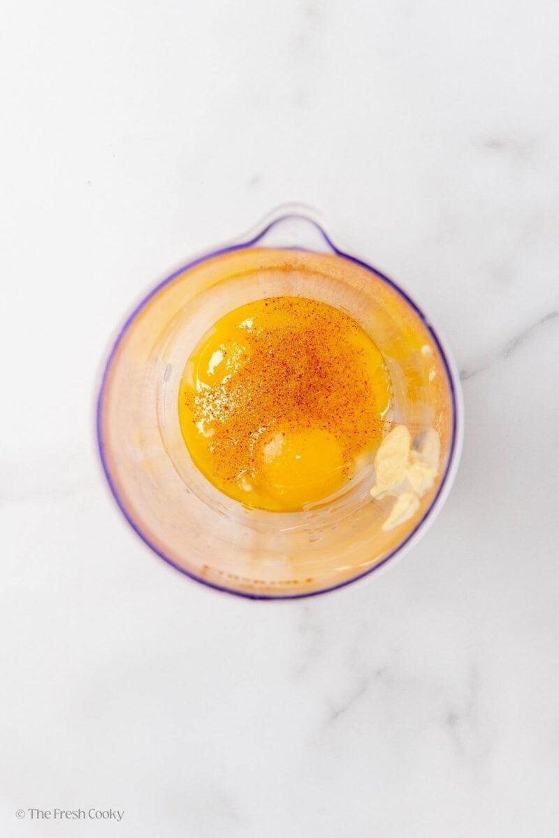 Ingredients needed to make the hollandaise sauce in a blender.