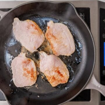 Searing Canadian bacon in a skillet.