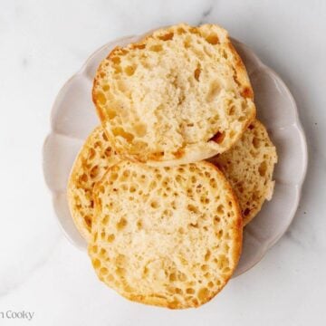 Overhead shot of toasted English muffin halves on a plate.