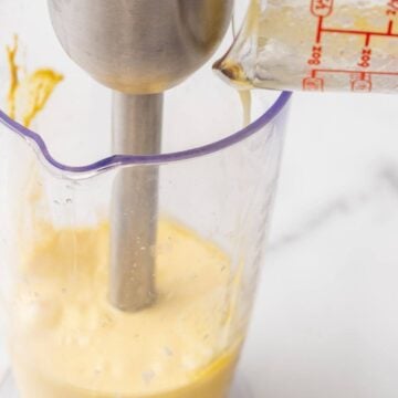 Using an immersion blender to making homemade hollandaise sauce.
