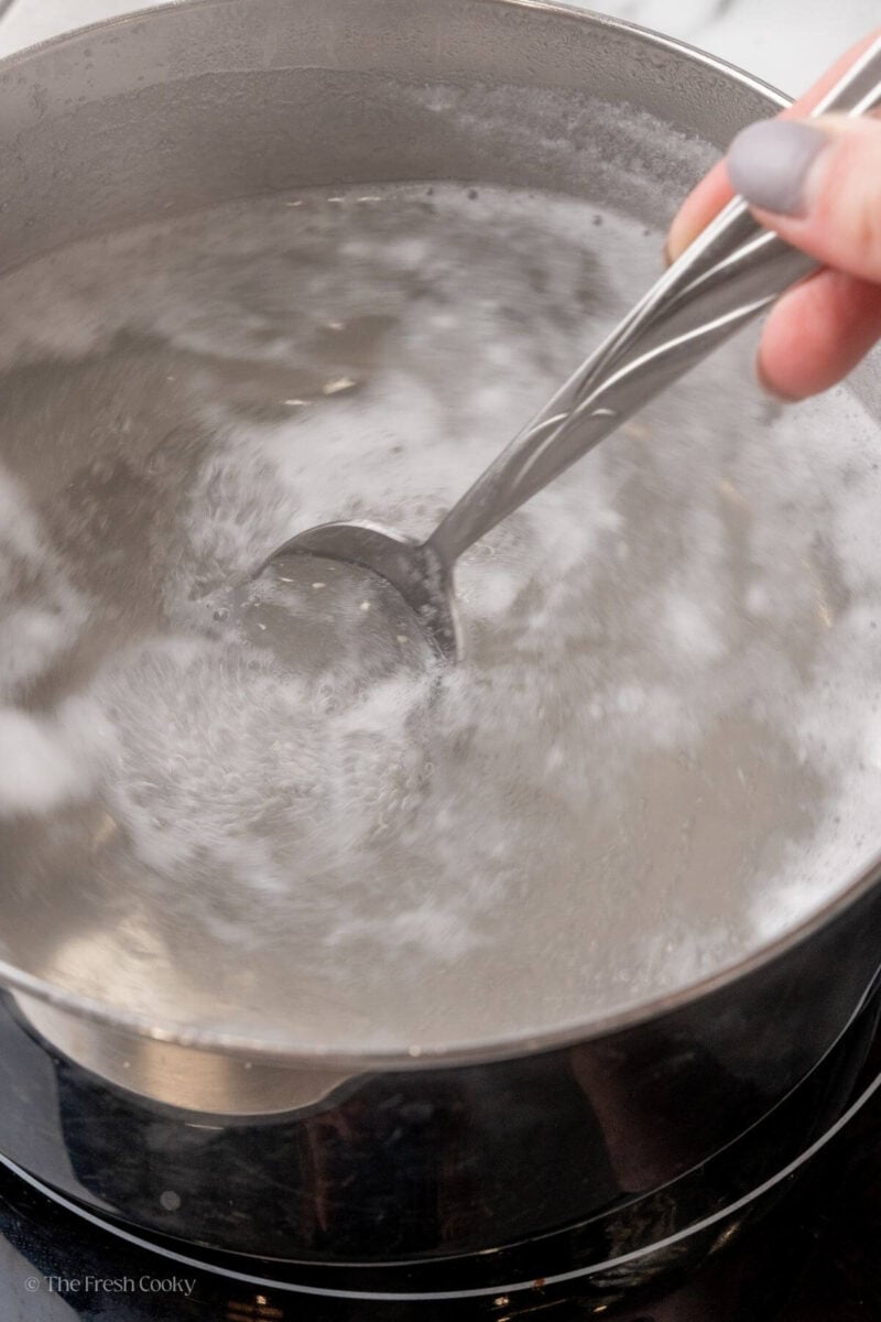 Swirling the boiling water in a large pot before adding the egg.