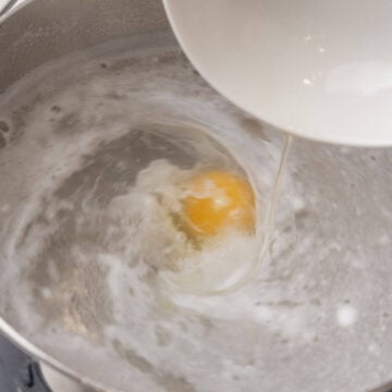 Pouring the egg into the boiling water to cook.