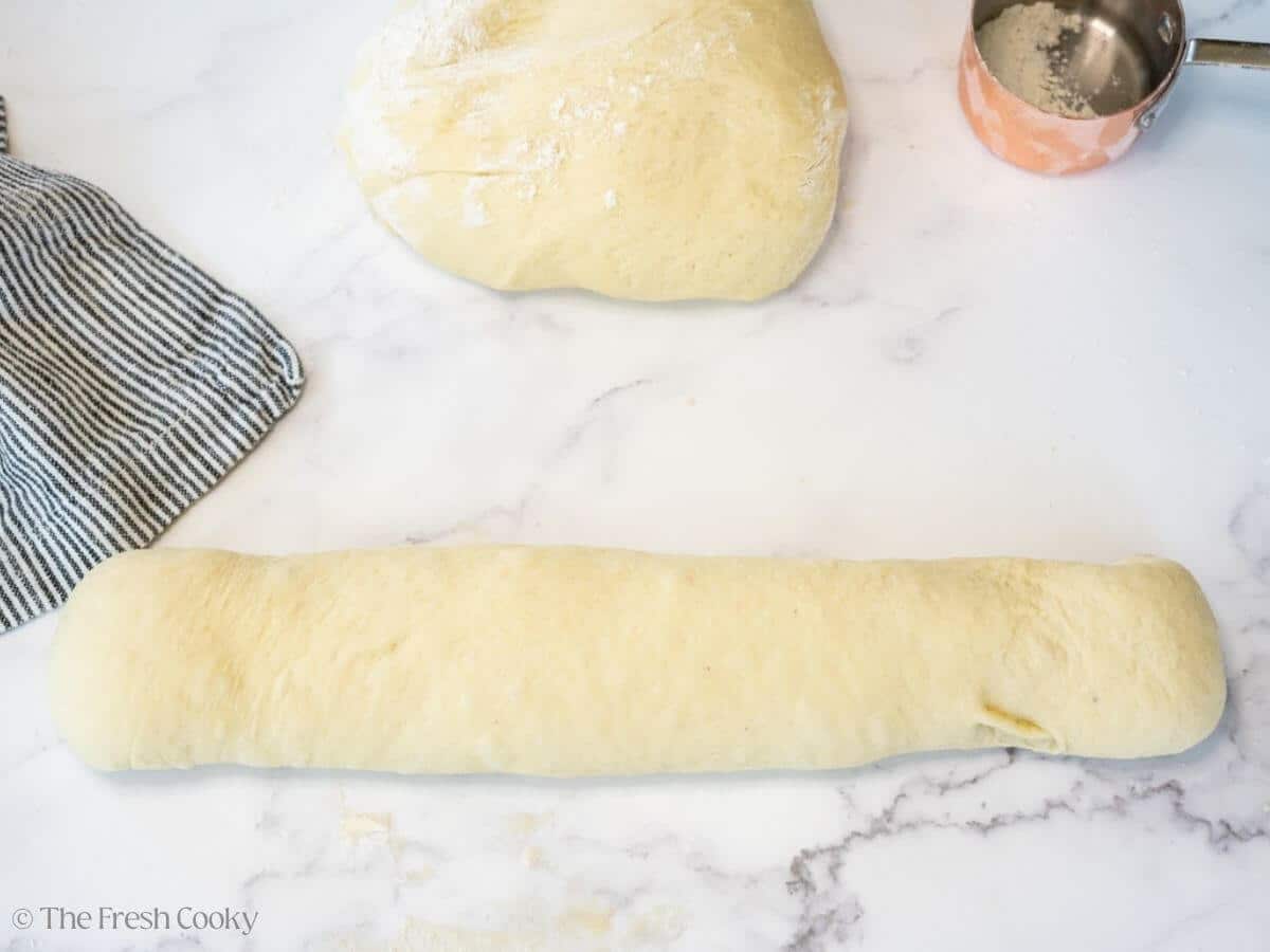 Flattened out dough rolled together into a log.