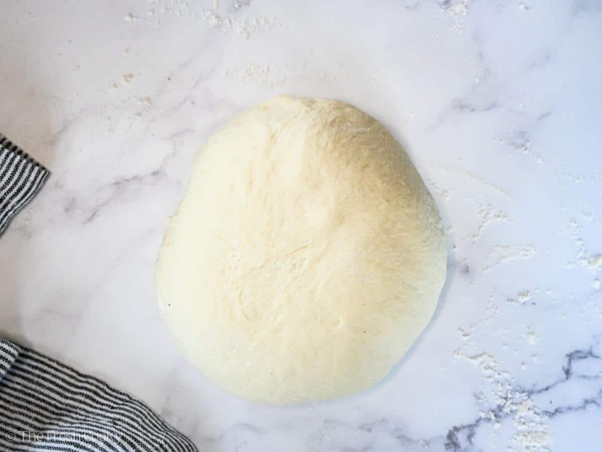 French bread dough turned out onto a floured surface.