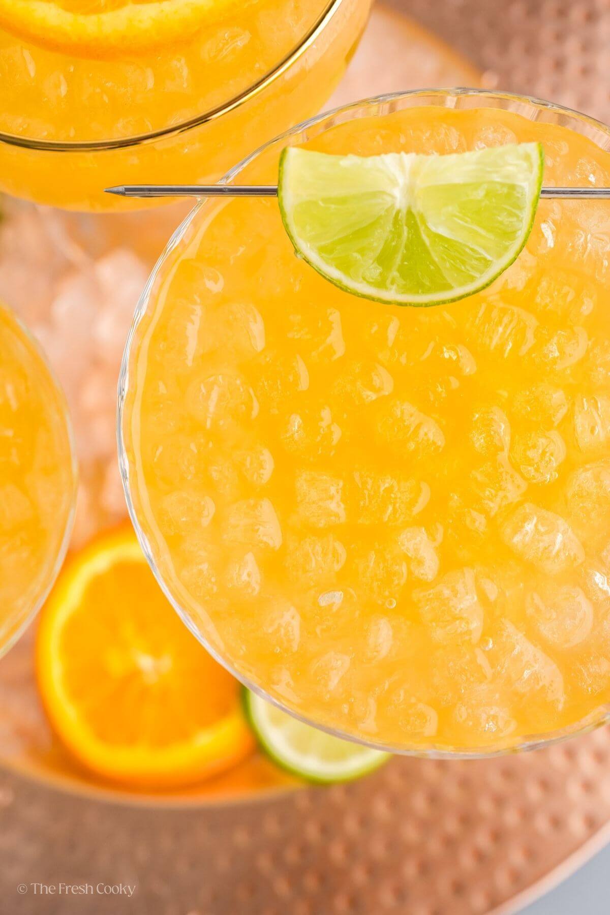 Overhead shot of a skinny margarita in a tall cocktail glass garnished with lime.