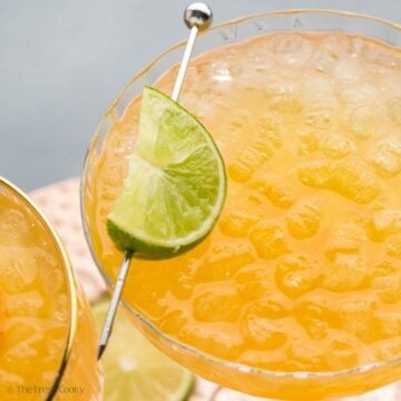 Skinny margarita in a coupe glass garnished with a lime wedge.