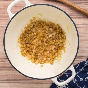 Sauteing onions and garlic in soup pot.