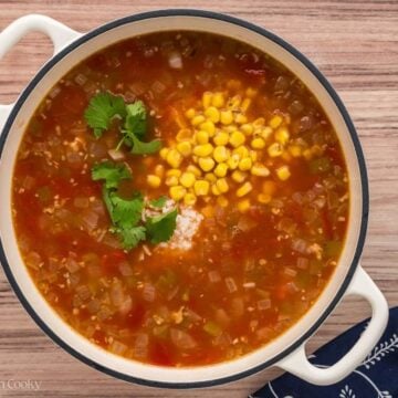 Adding rice, corn, cilantro to the soup.