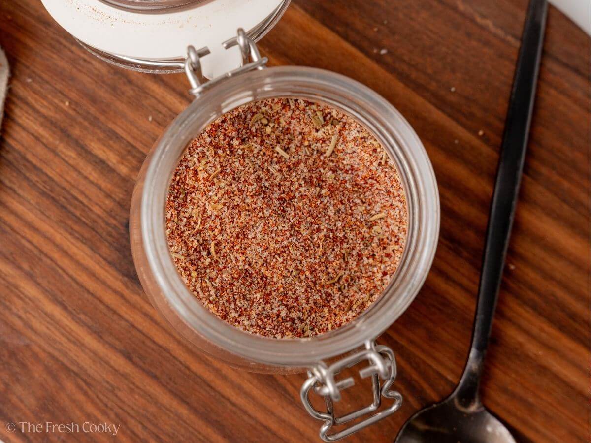Overhead shot of steak seasoning stored in a small jar.