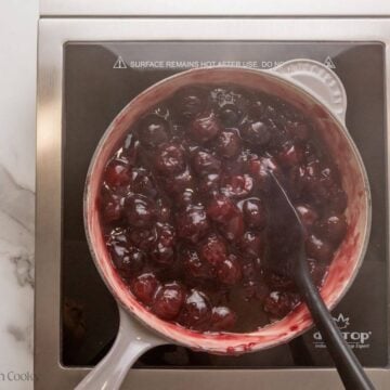 Cherries cooking in a skillet.