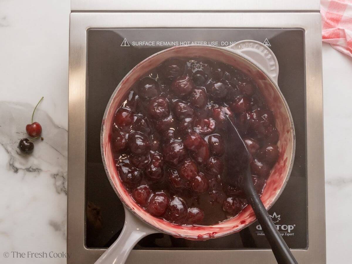 Cherries cooking in a skillet.