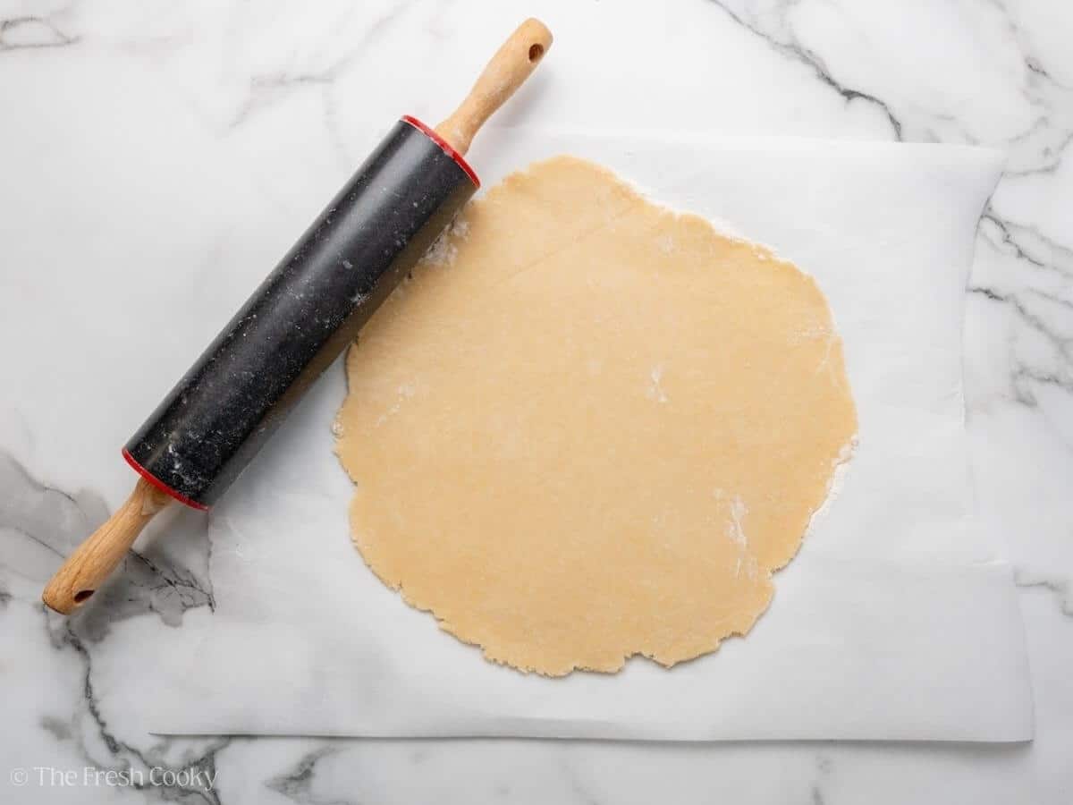 One disc of pie dough rolled out into a flat circle.