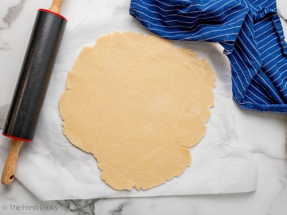Pie dough rolled out into a thin circle.