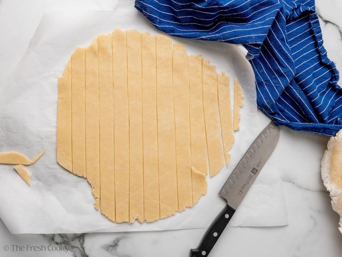 Pie dough sliced into thin strips.
