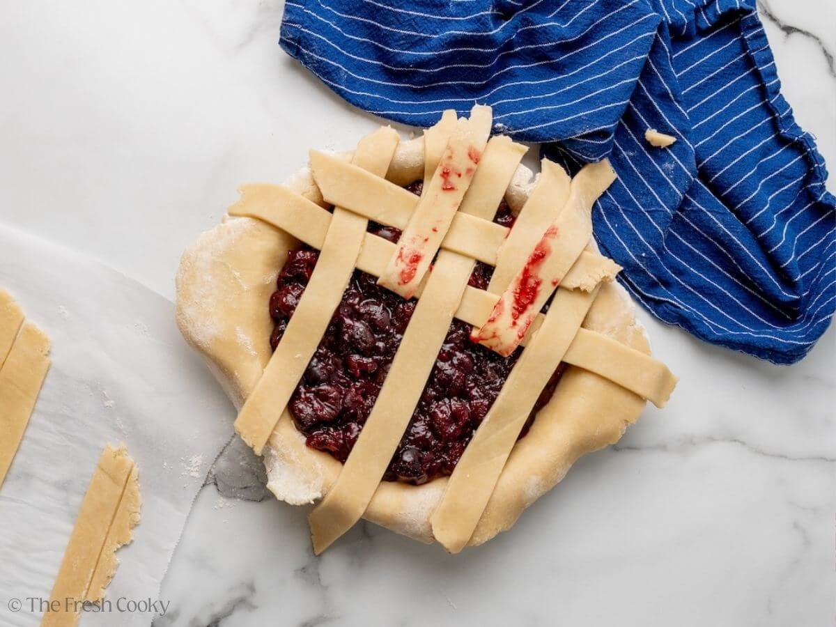 Creating the lattice pattern with the strips of pie dough.