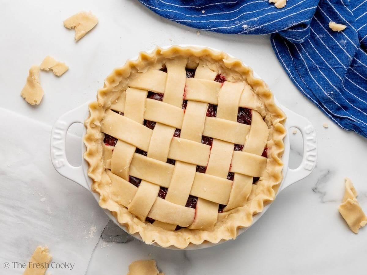 Edges of the pie dough trimmed and crimped before baking.