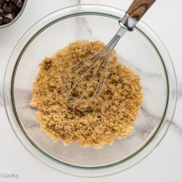 Whisking together the sugar, vanilla, and salt in a bowl.