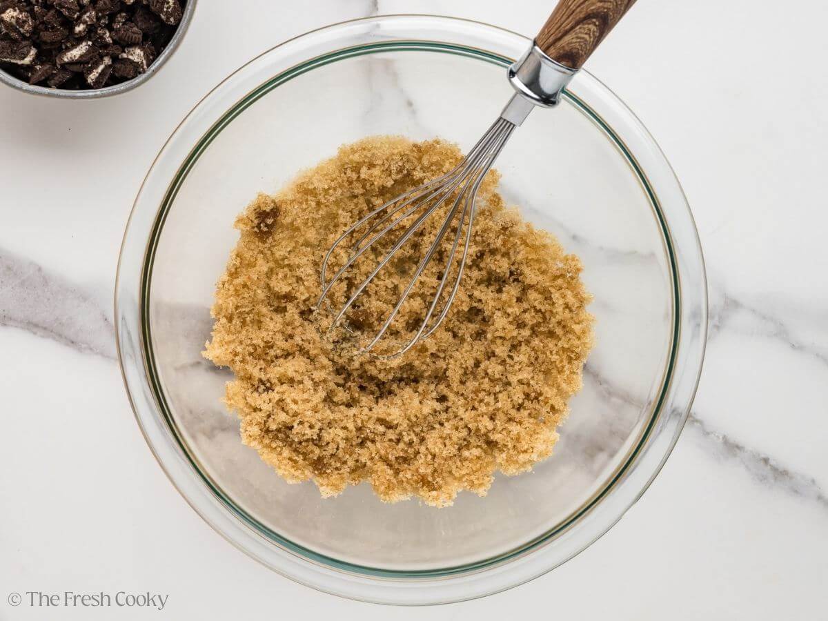 Whisking together the sugar, vanilla, and salt in a bowl.