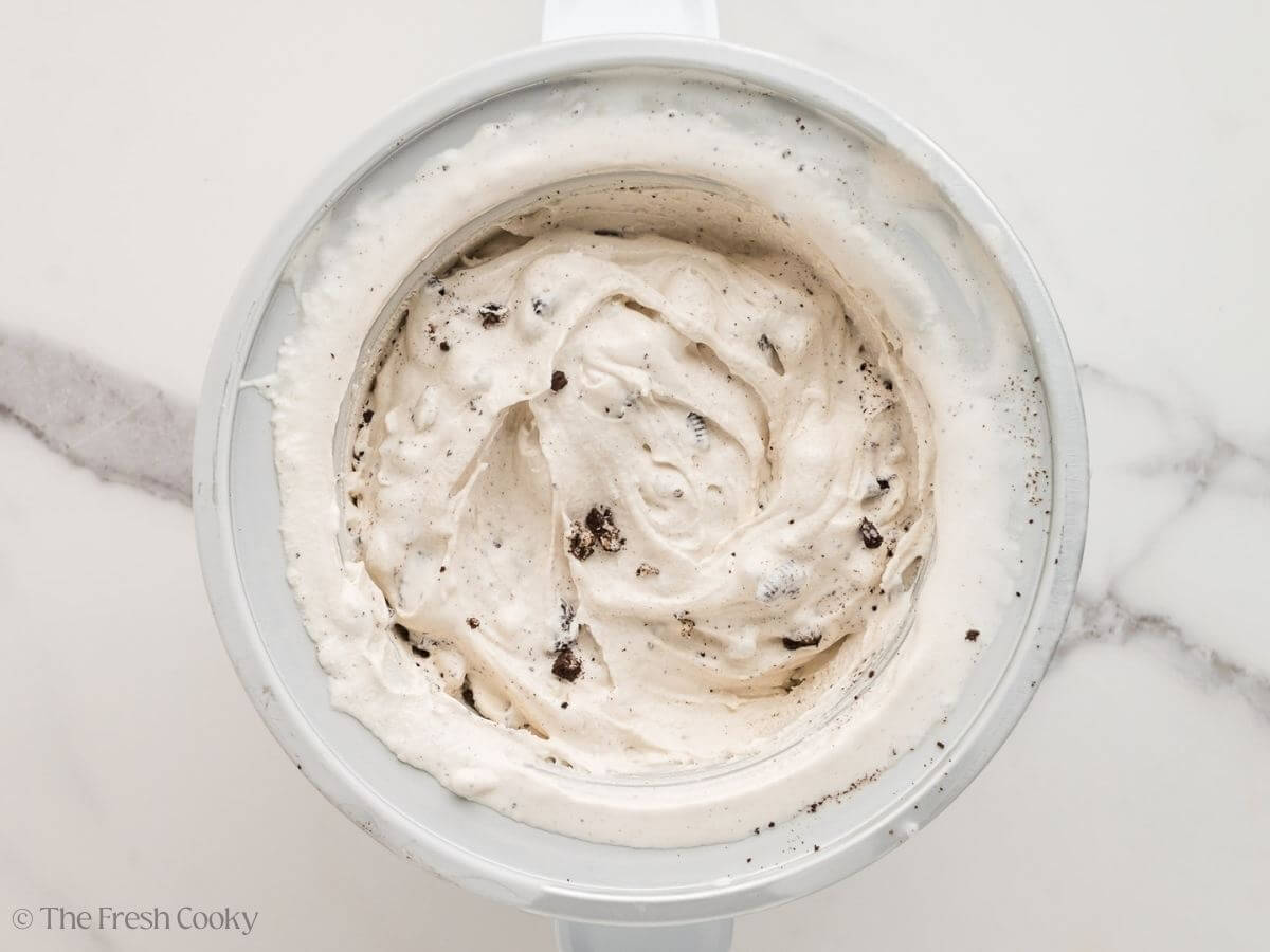 Cookies and cream ice cream in the ice cream maker after churning.
