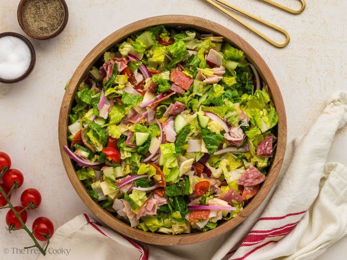 Italian grinder salad ingredients all mixed together in a salad bowl.