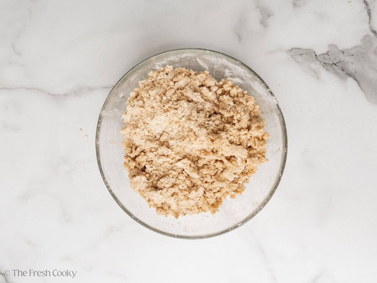 Crisp topping mixed with butter in a bowl.