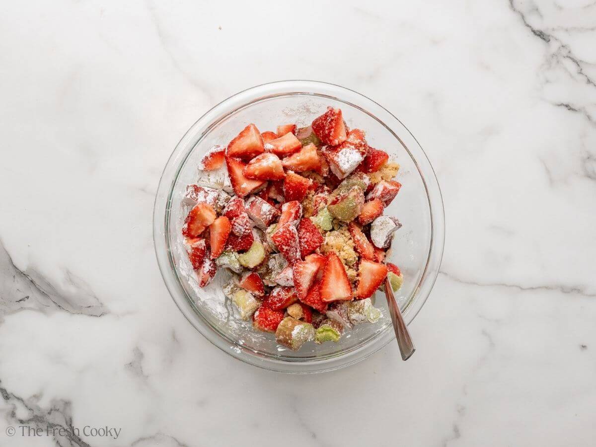Strawberry rhubarb filling mixture in a bowl after being mixed together.