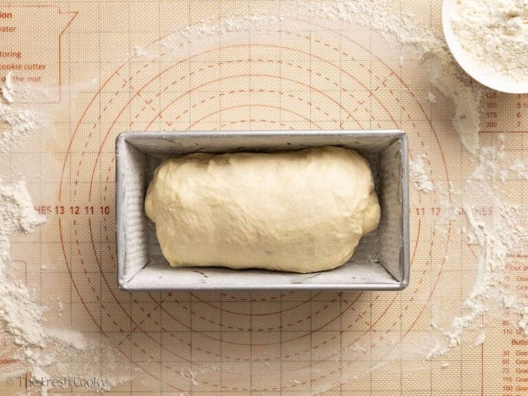 Bread dough placed in the floured loaf pan.