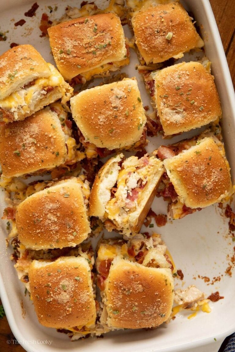 Overhead shot of chicken bacon ranch sliders in a baking dish with some tilted to the side.