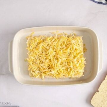 Layer of shredded cheese on top of the bottom half of the rolls.