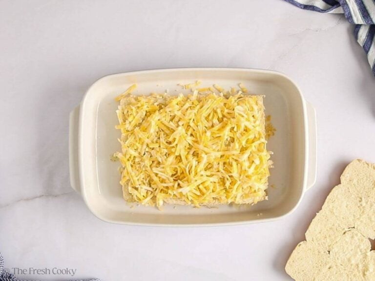 Layer of shredded cheese on top of the bottom half of the rolls.