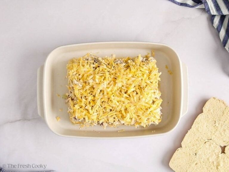 Another cheese layer placed on top of the bottom half of the rolls.